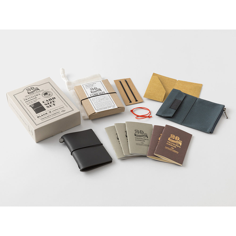 Collection of leather-bound notebooks and accessories on a white background