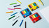 Colorful pencils and sets on a light blue background
