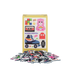 Pile of colorful puzzle pieces in front of a box with illustrations on a white background