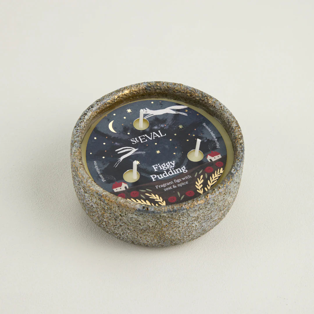 Candle with decorative label on a light gray background