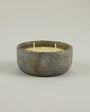 Ceramic bowl with a candle on a light gray background