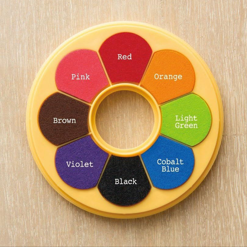Color wheel with labeled colors on a wooden background