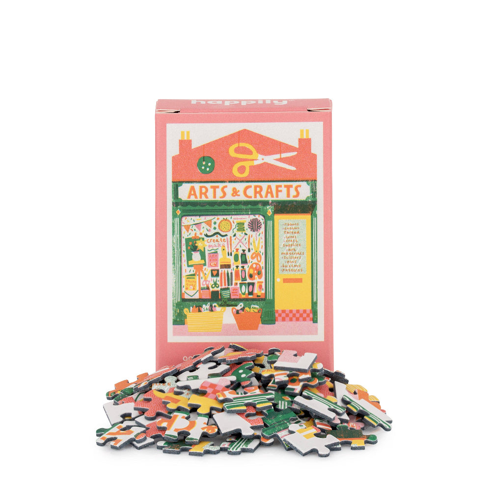Puzzle with pieces and packaging featuring 'Arts & Crafts' theme on a white background