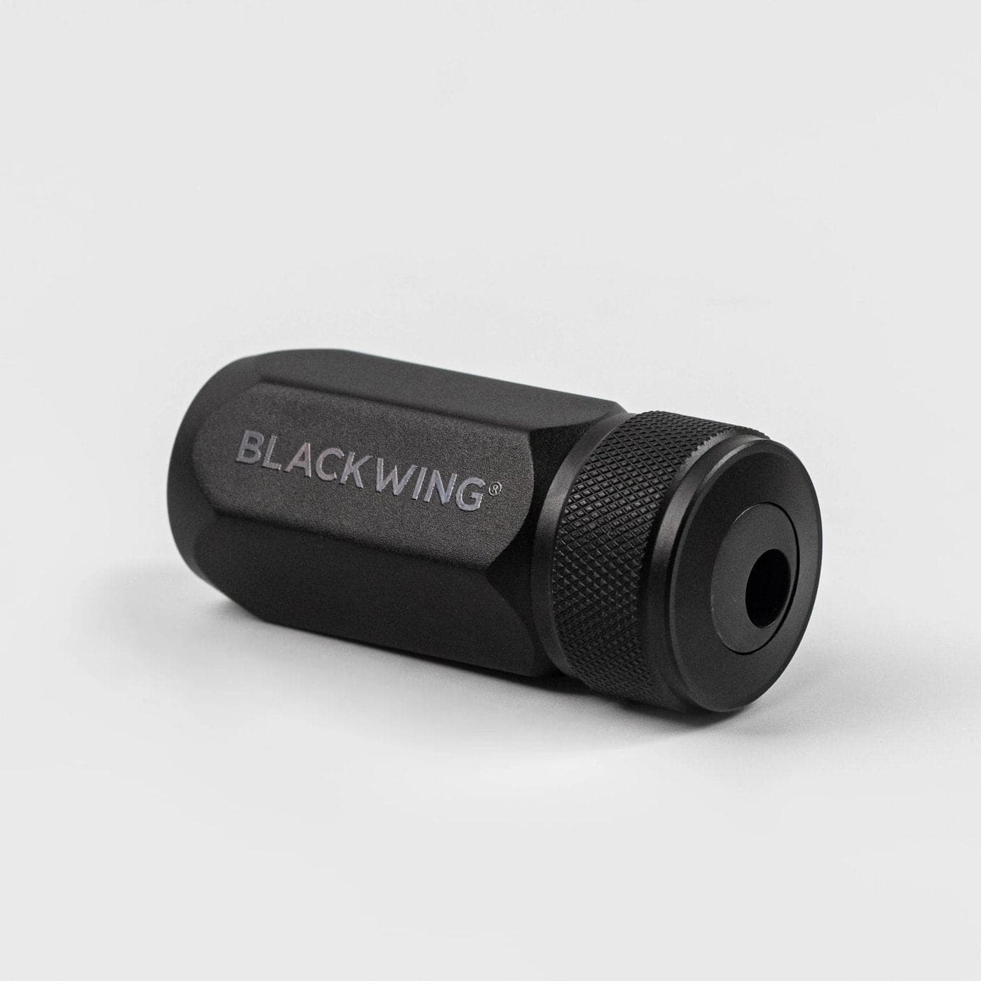 Black cylindrical object with 'BLACKWING' branding on a light gray background