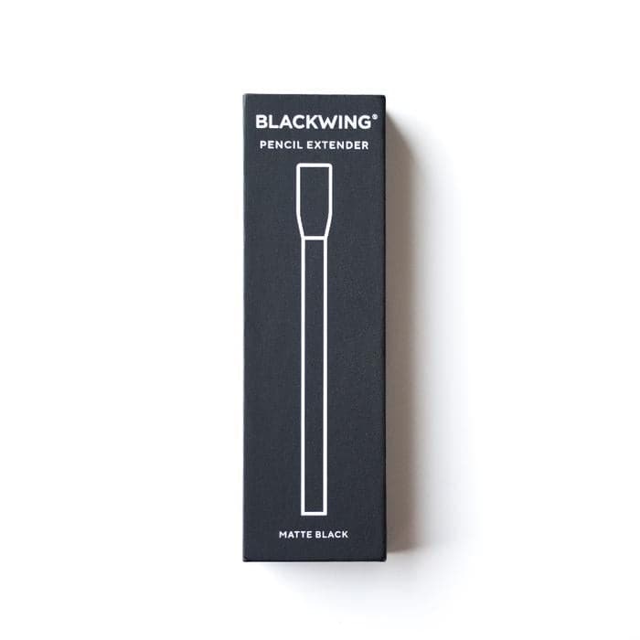 A tall, narrow black product box for a BLACKWING pencil extender, featuring a white line drawing of the extender and the text 'MATTE BLACK' at the bottom, set against a plain white background.
