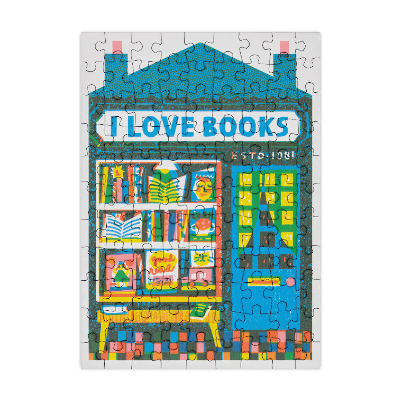 Jigsaw puzzle with a colorful design of a bookshop and 'I Love Books' sign on a white background.