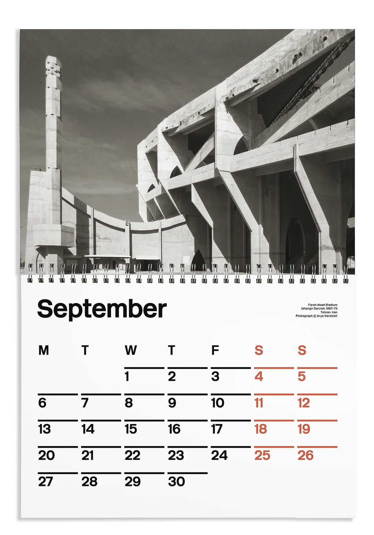 A single-page spiral calendar page showing the month of September. The top portion features a black-and-white architectural photograph with a tall tower and angular concrete structures.