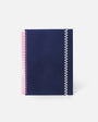 Navy blue notebook with pink and white spiral binding on a white background