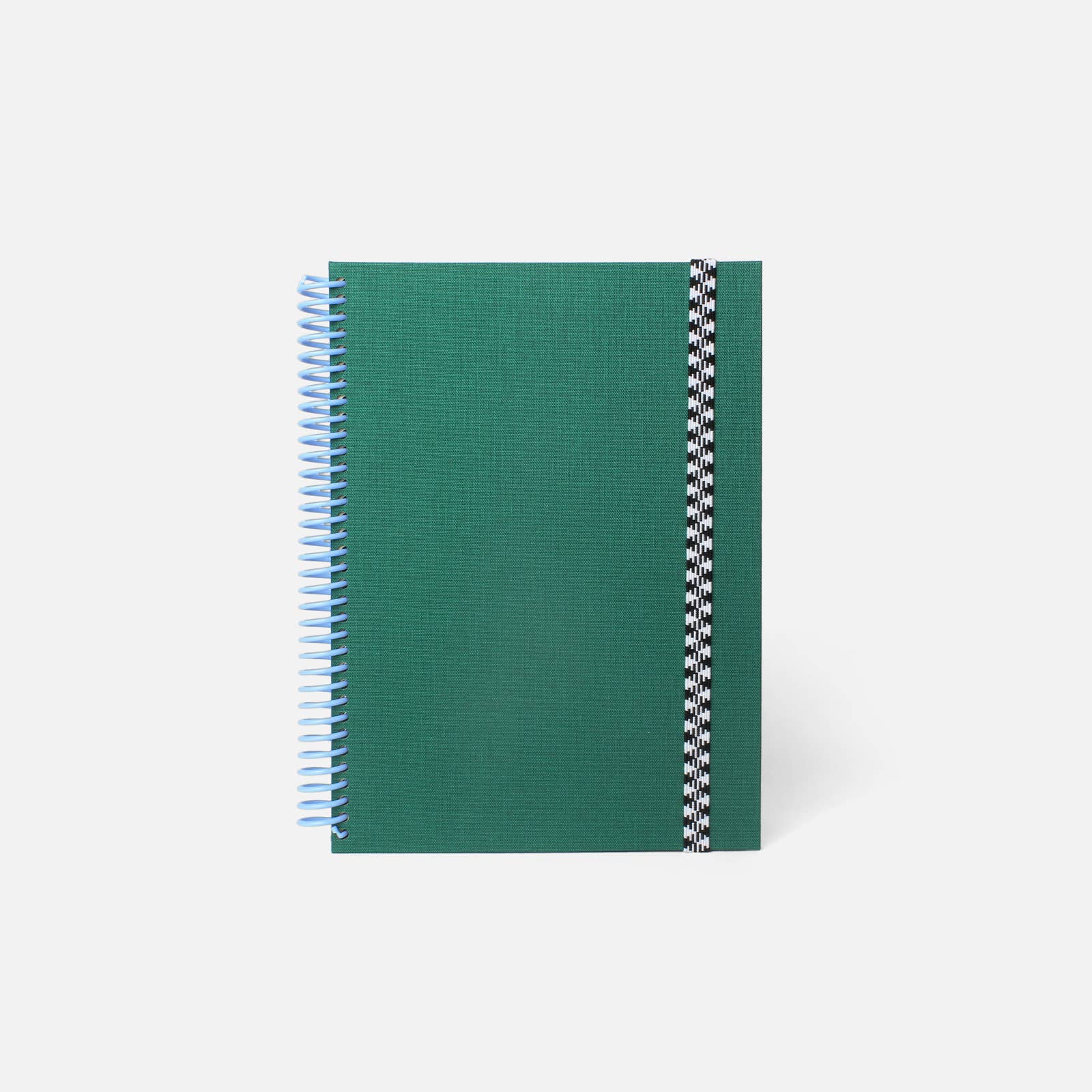Green notebook with spiral binding on a white background