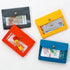 Four colorful mini wallets with various items on a white background