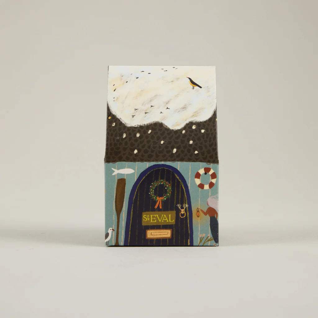 Notebook with a decorative cover featuring a door, wreath, and various elements on a beige background