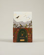 Sheval product packaging with a design of birds and a door on a beige background
