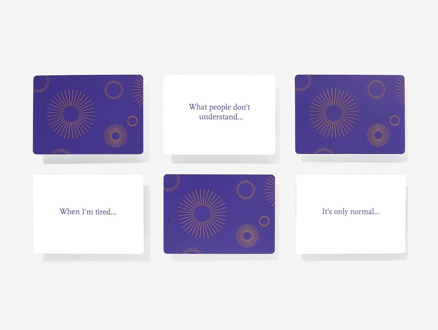 Set of four cards with purple and white design on a white background