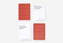 Two red playing cards with geometric patterns on a white background
