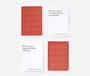 Two red playing cards with geometric patterns on a white background