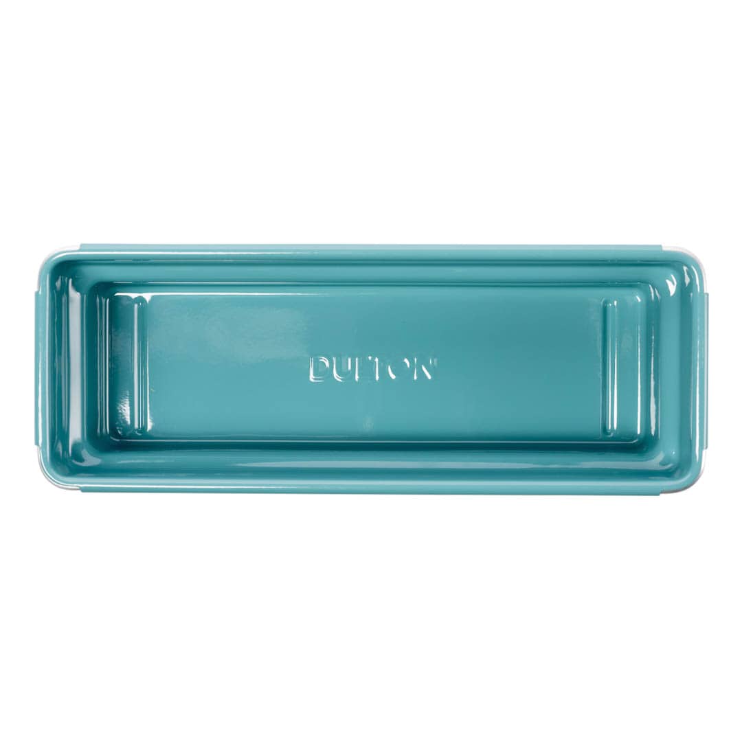 A rectangular teal ceramic bread pan with 'DUTTON' embossed in the center, shown from a top-down view on a white background.