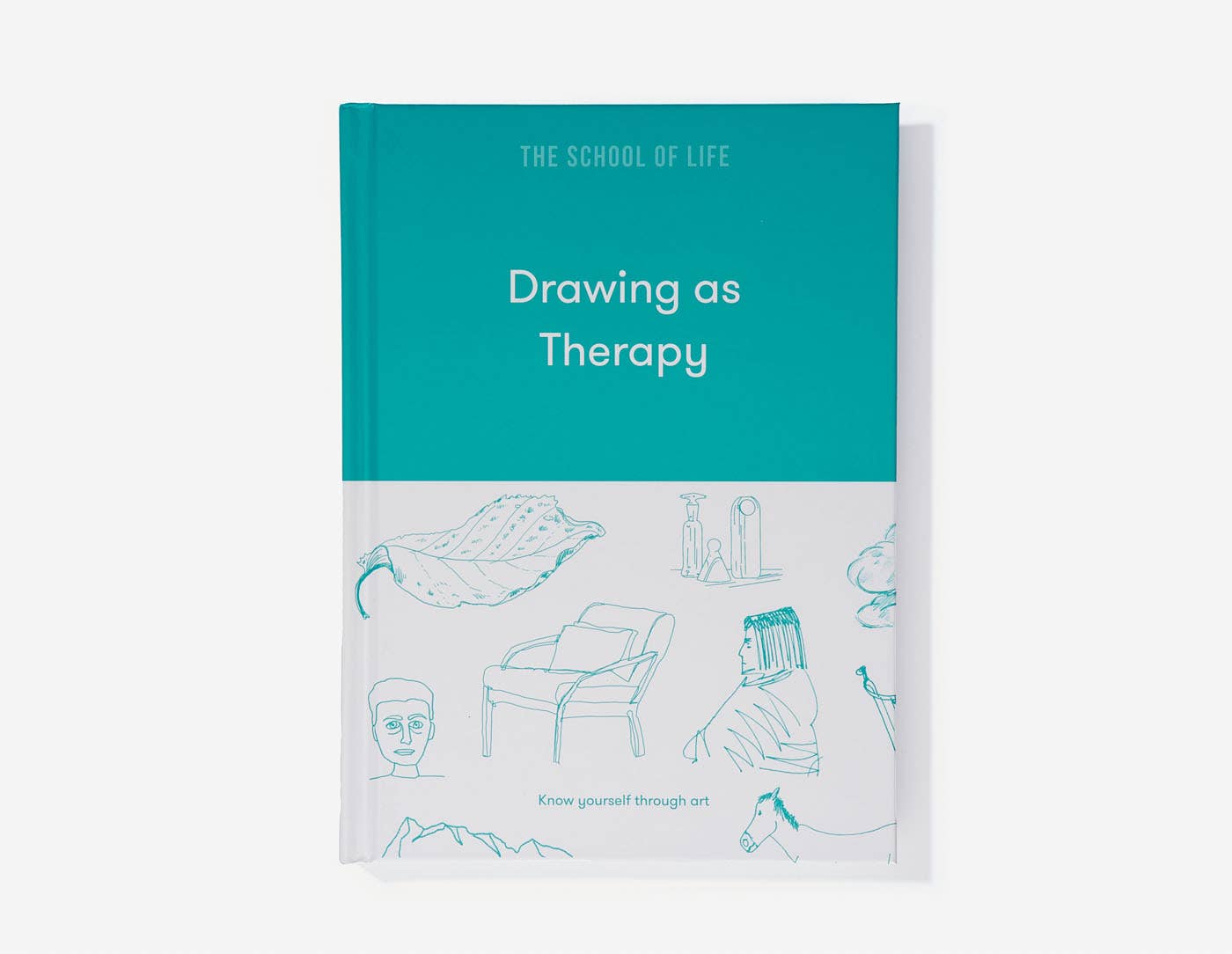 A book titled 'Drawing As Therapy' with a turquoise cover and a minimalist illustration of a chair on the front.