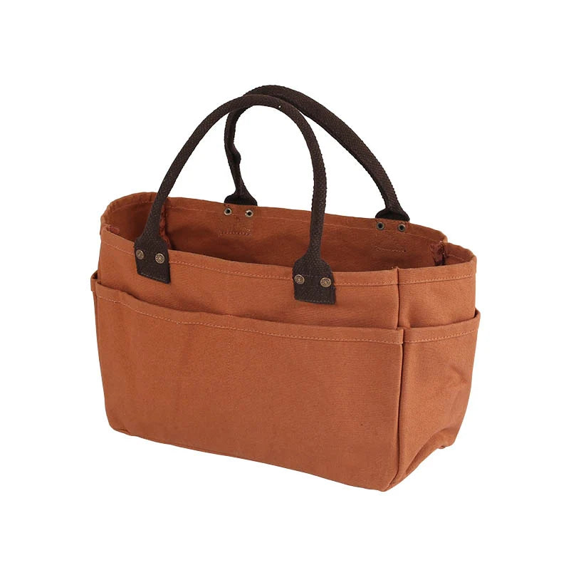 A brown canvas organizer tote bag with dark brown leather handles and snap closures, shown on a plain white background.