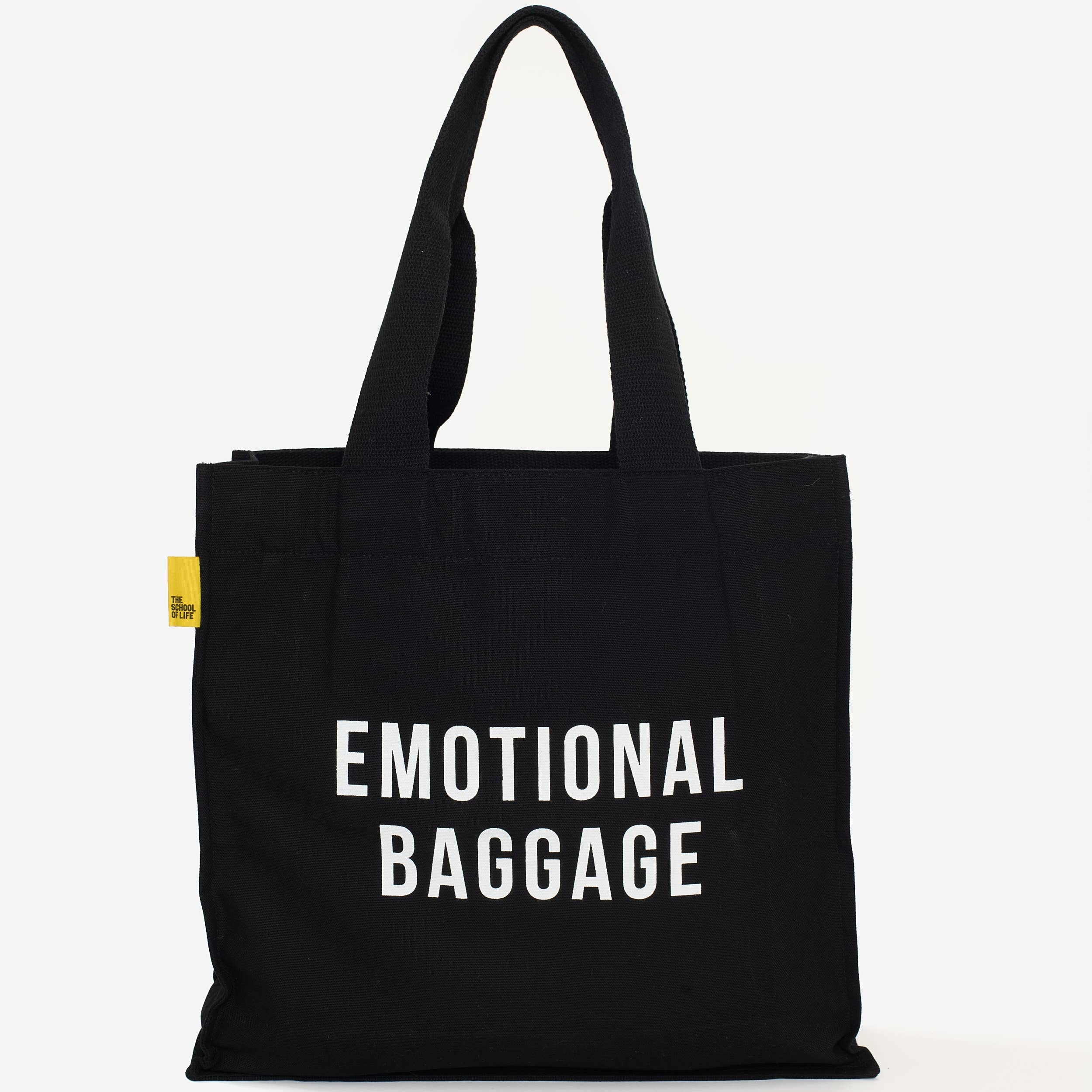Black tote bag with 'EMOTIONAL BAGGAGE' text on a white background