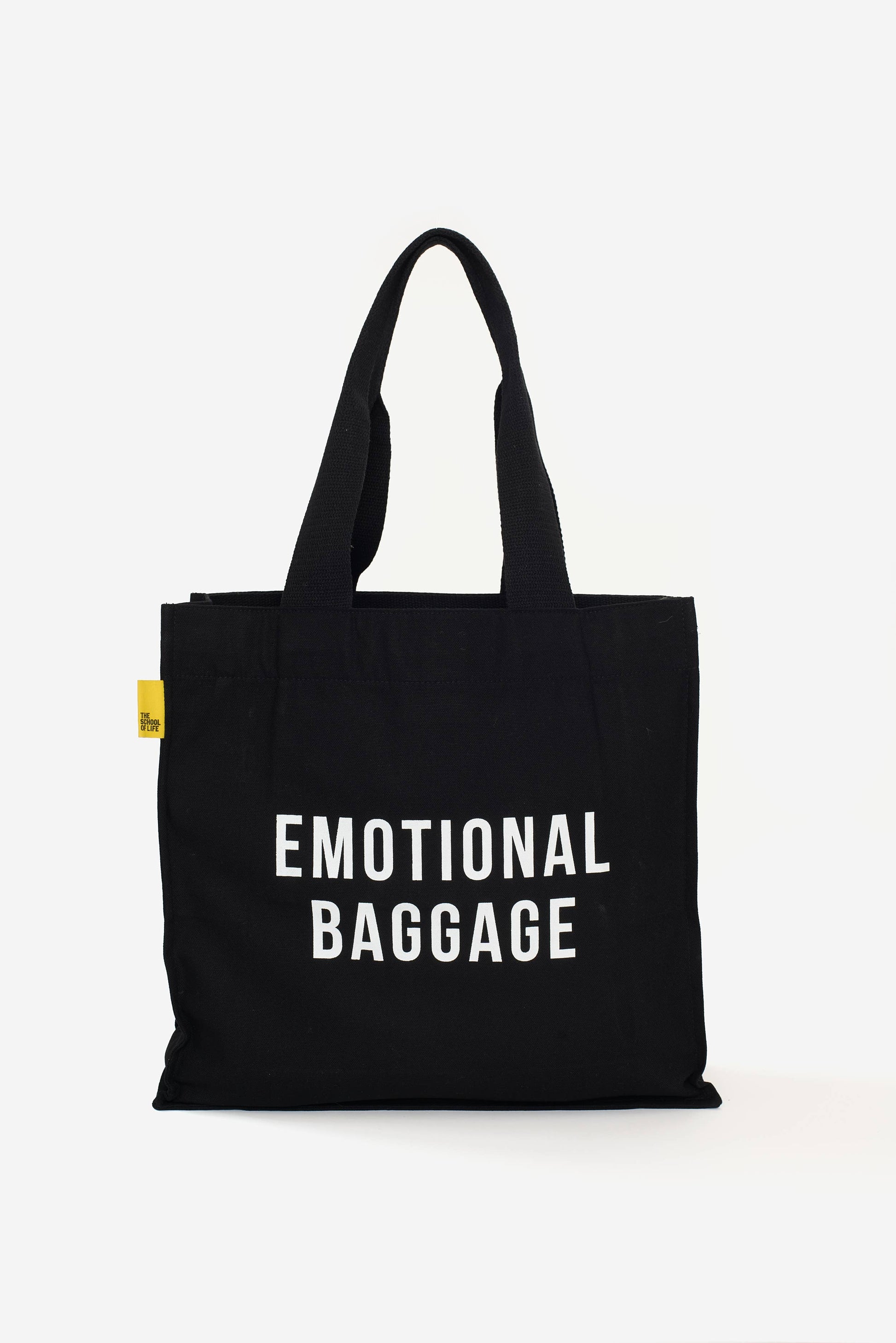 Black tote bag with 'EMOTIONAL BAGGAGE' text on a white background