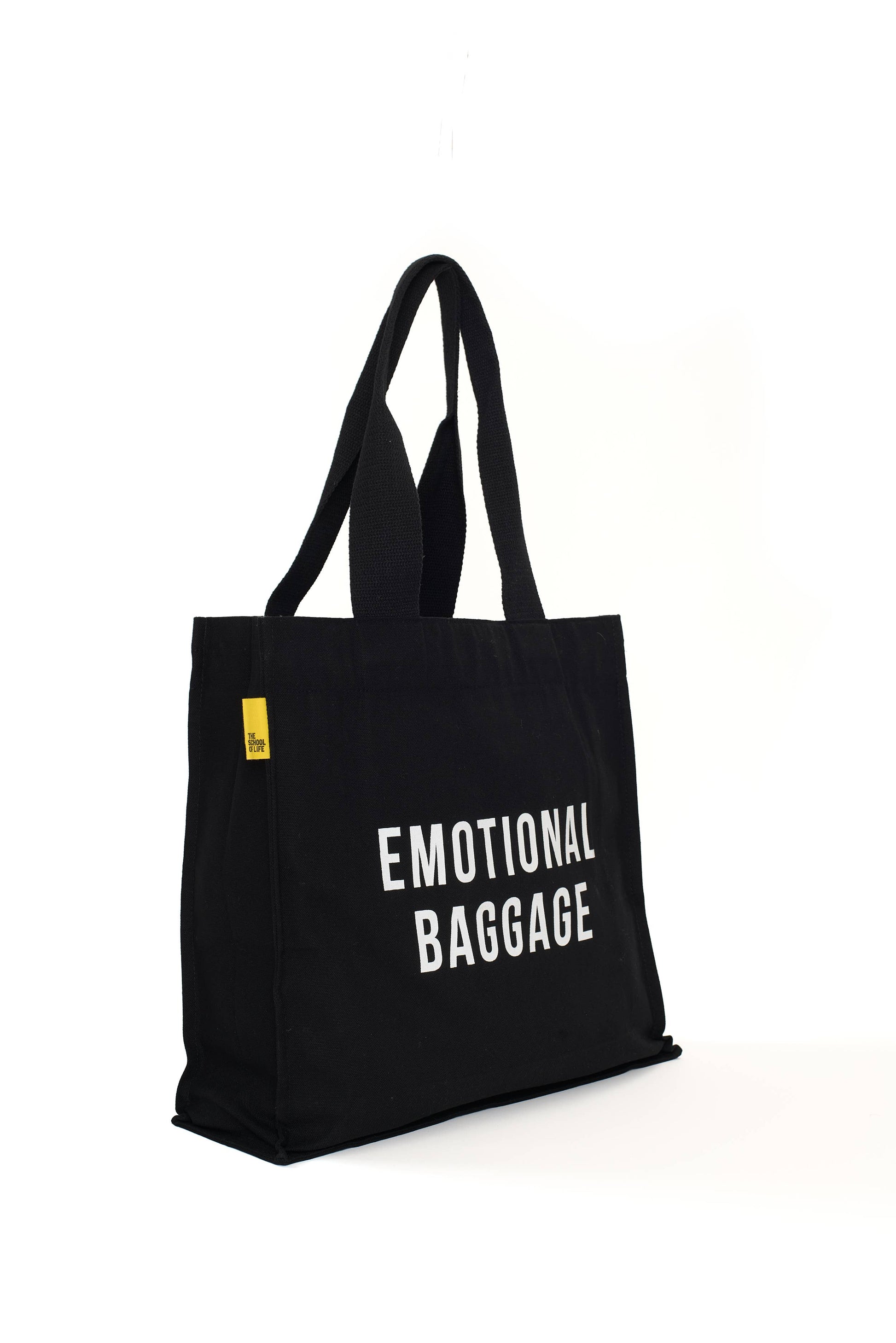Black tote bag with 'EMOTIONAL BAGGAGE' text on a white background