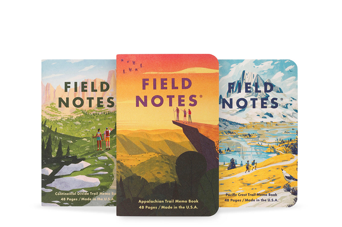 Three 'Field Notes' notebooks with scenic covers on a white background