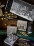 Decorative items including cards and a candle on a surface with a dark background