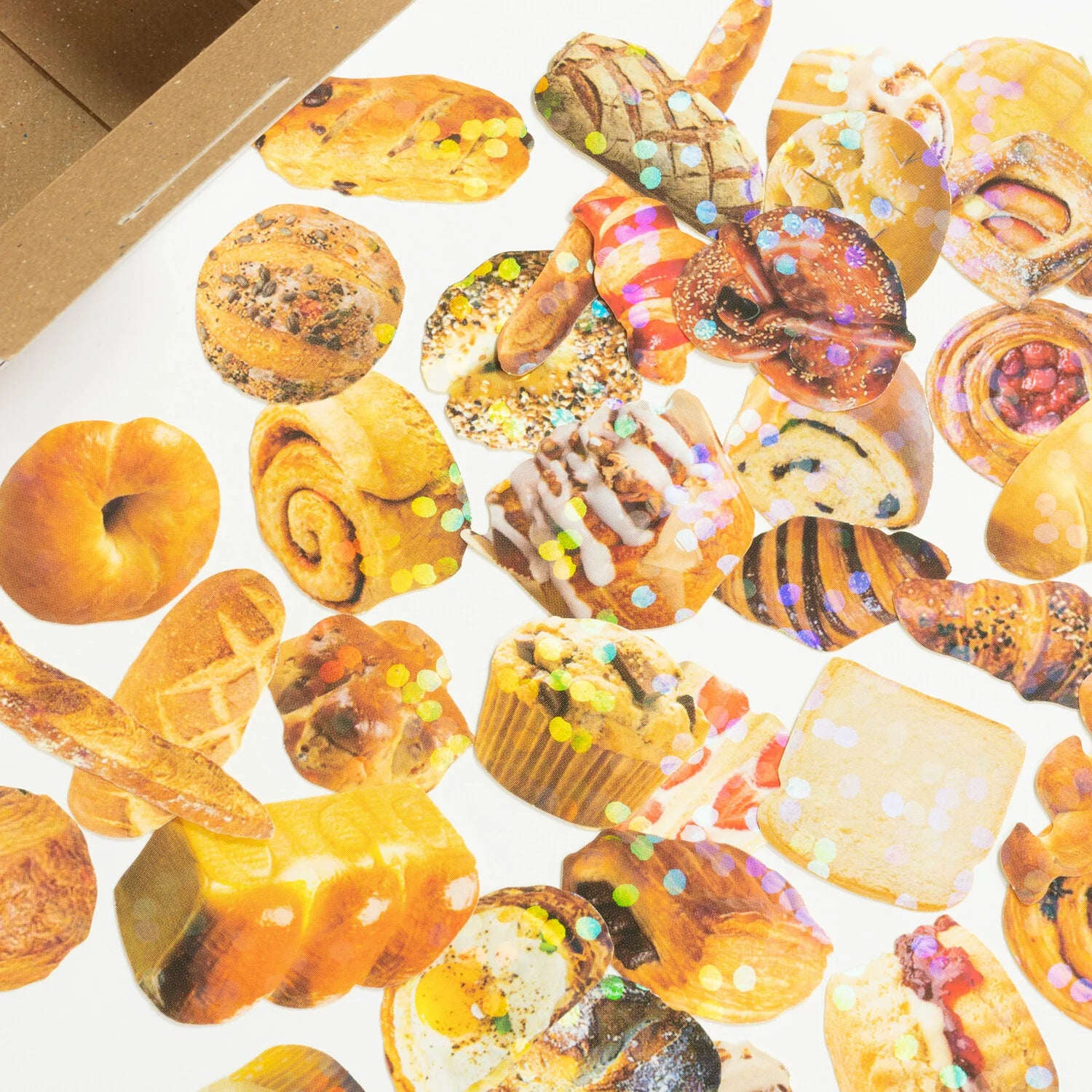 Assorted pastries on a white surface with a cardboard box in the background