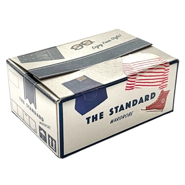 Box from 'The Standard Wardrobe' with clothing images on a white background