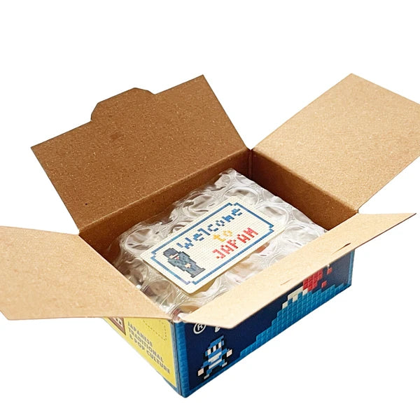 Open cardboard box with a plastic-wrapped item and 'Welcome to Japan' sign.