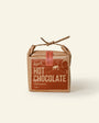 Box of Härth Hot Chocolate with cinnamon flavor on a beige background