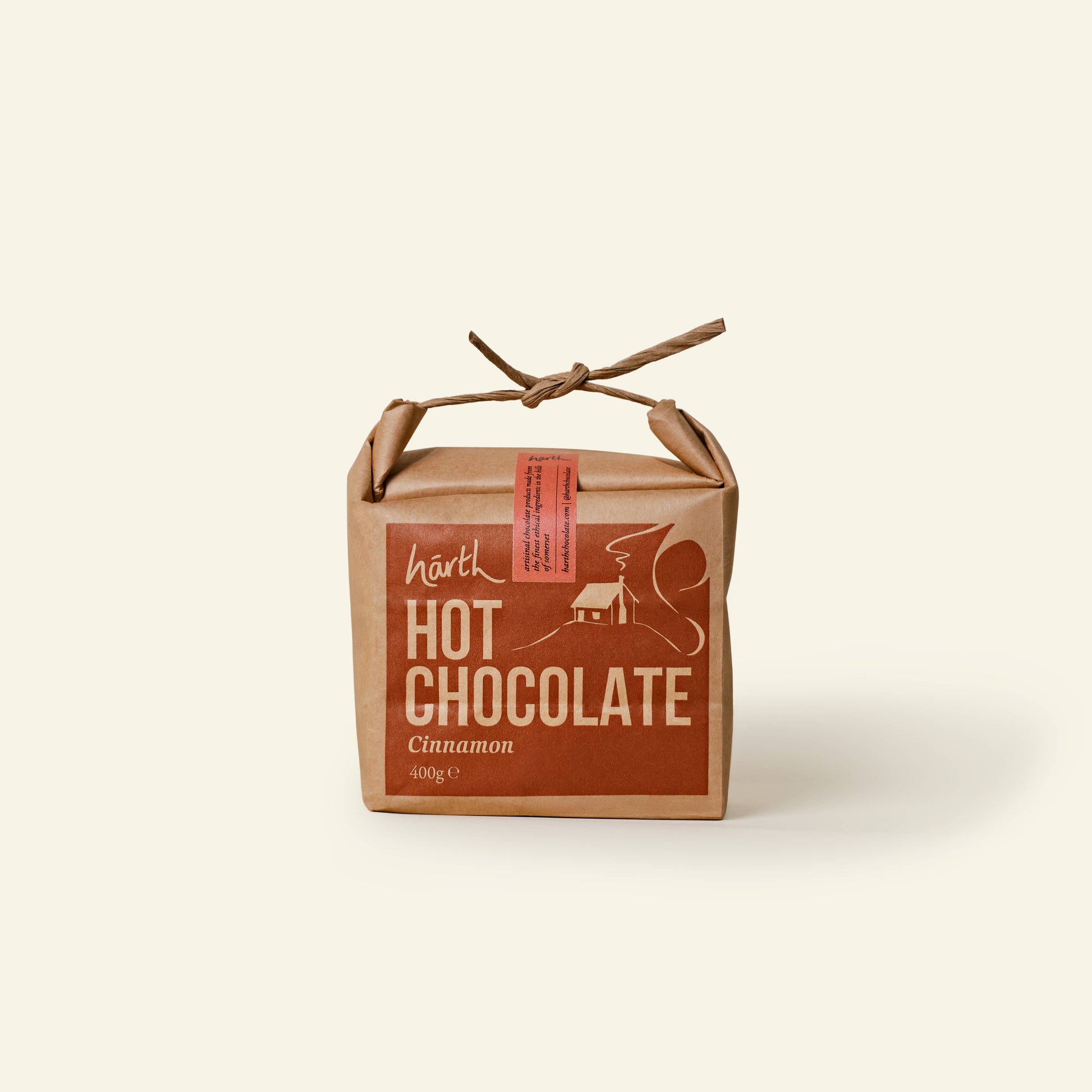 Box of Härth Hot Chocolate with cinnamon flavor on a beige background