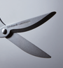 Close-up of a pair of scissors with Nakabayashi Stainless Steel branding on a gray background