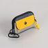Small pouch with yellow flap and black strap on a light gray background
