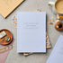 Notebook on a table with stationery items