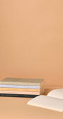 Stack of books with a beige background