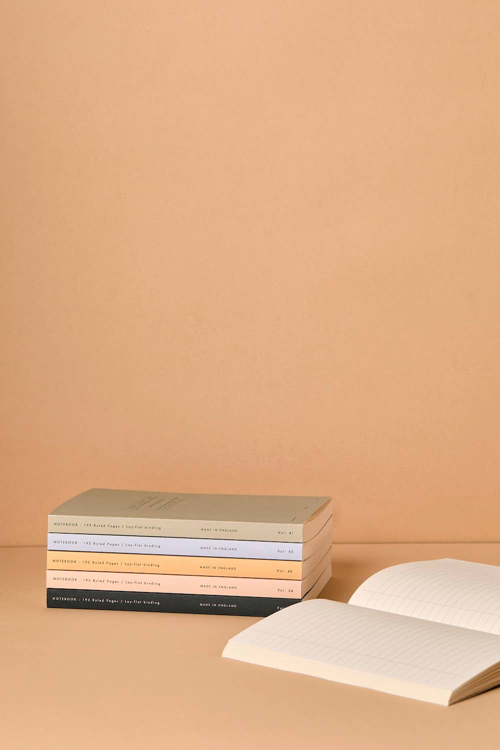 Stack of books with a beige background