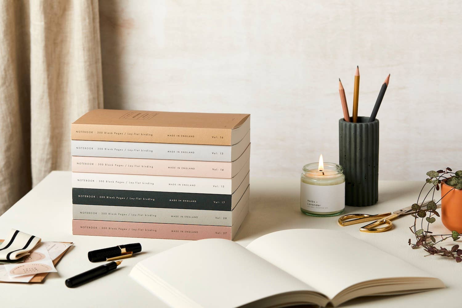 stack of Katie Leamon notebooks on a table