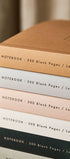Close up of staked Katie Leamon notebooks