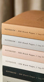 Close up of staked Katie Leamon notebooks