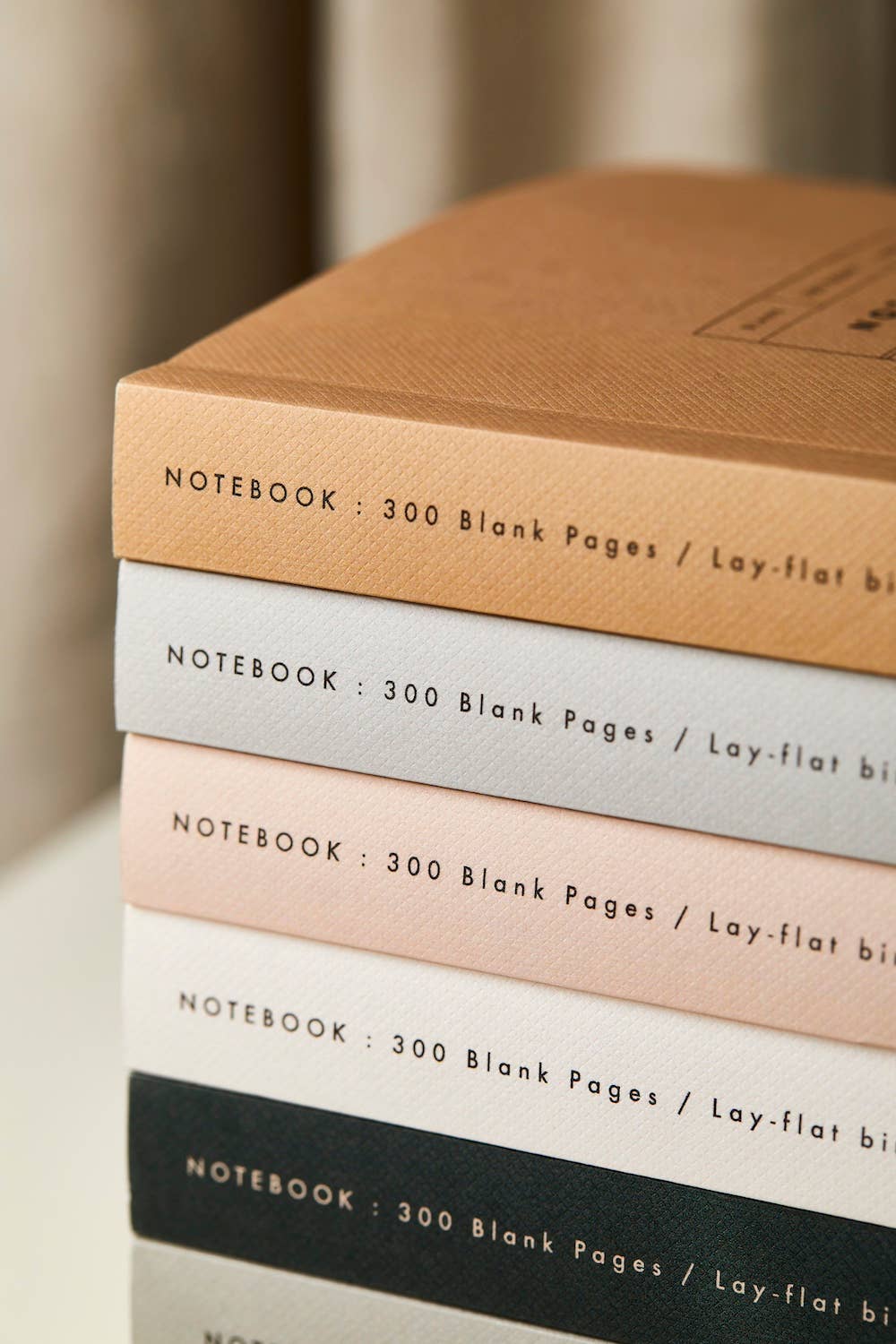 Close up of staked Katie Leamon notebooks