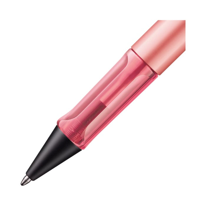 Pink pen with a black cap on a white background