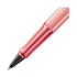 Pink pen with a black clip on a white background