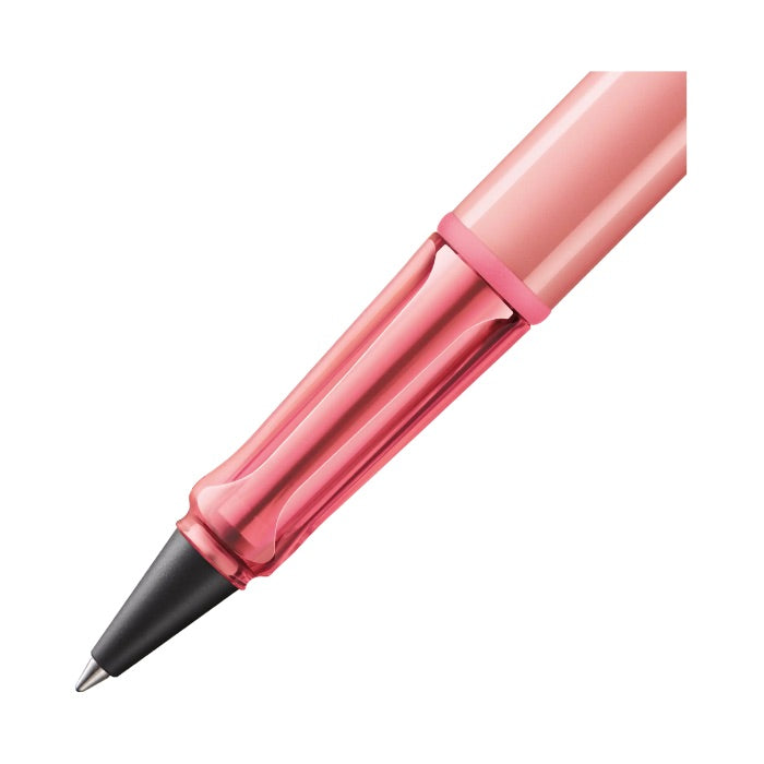 Pink pen with a black clip on a white background