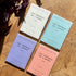 Four colorful diaries titled 'Les Agendas de l'Année' on a wooden surface.