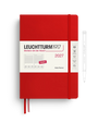 A red Leuchtturm1917 2027 daily planner with a white paper band around the middle, shown closed with a red ribbon bookmark. A white pen is pictured to the right as an included accessory on a clean white background.