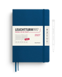 A Leuchtturm1917 2027 daily planner in indigo blue with a white paper band around the middle, shown on a white background with a pen illustration to the right.