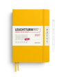 A Leuchtturm1917 2027 daily planner in a bright yellow hardcover, shown closed with a white paper band around the middle and two yellow ribbon bookmarks. A thin pen outline is visible to the right on a clean white background.