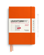 An orange Leuchtturm1917 2027 weekly planner and notebook with a white front label, shown closed with an orange ribbon bookmark. A white pen outline is visible to the right on a clean white background.