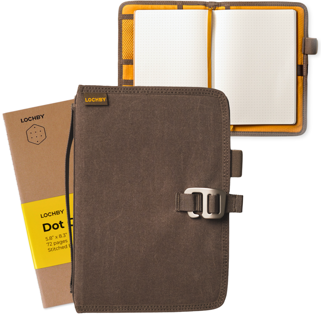 Brown notebook with a buckle, open to show lined pages, on a white background.